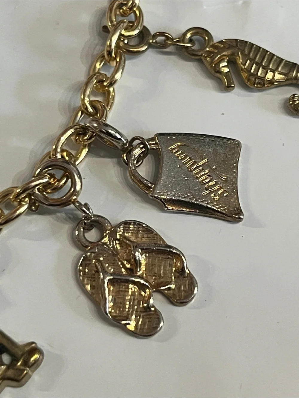 DIAMOND INTERNATIONAL GOLDTONE CHARM BRACELET